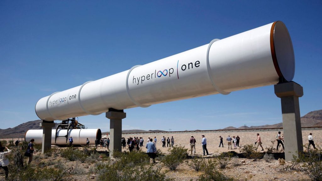 journalists-and-guests-look-over-tubes-following-a-propulsion-open-air-test-at-hyperloop-one-in-north-las-vegas_5595949